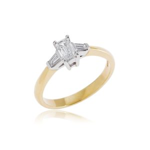 18ct Yellow gold emerald cut diamond ring with tapered baguette diamond shoulders