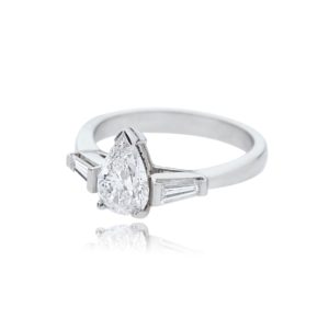 Platinum pear cut diamond ring with tapered baguette cut diamond