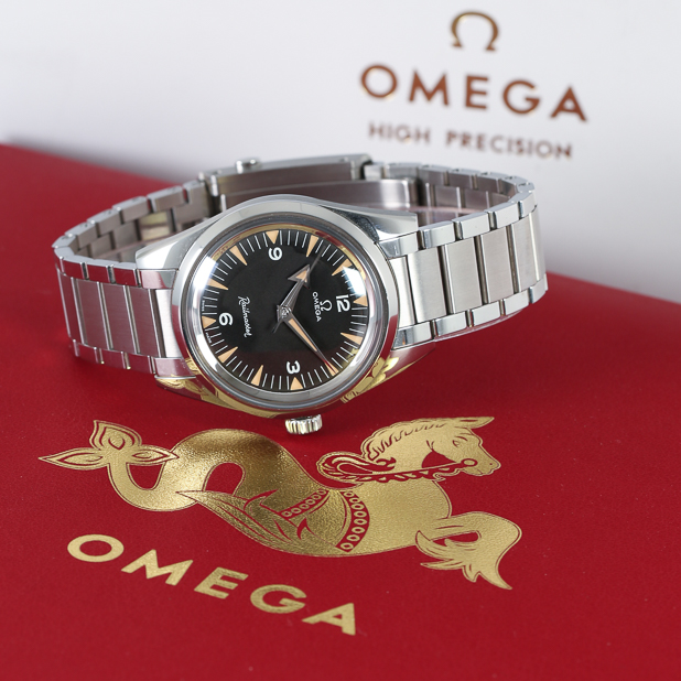 silver-omega-watch-on-red-background