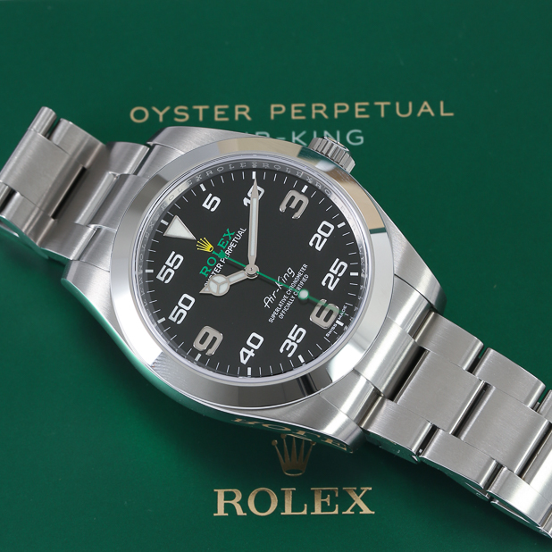 rolex-oyster-perpetual-on-top-of-branded-green-background